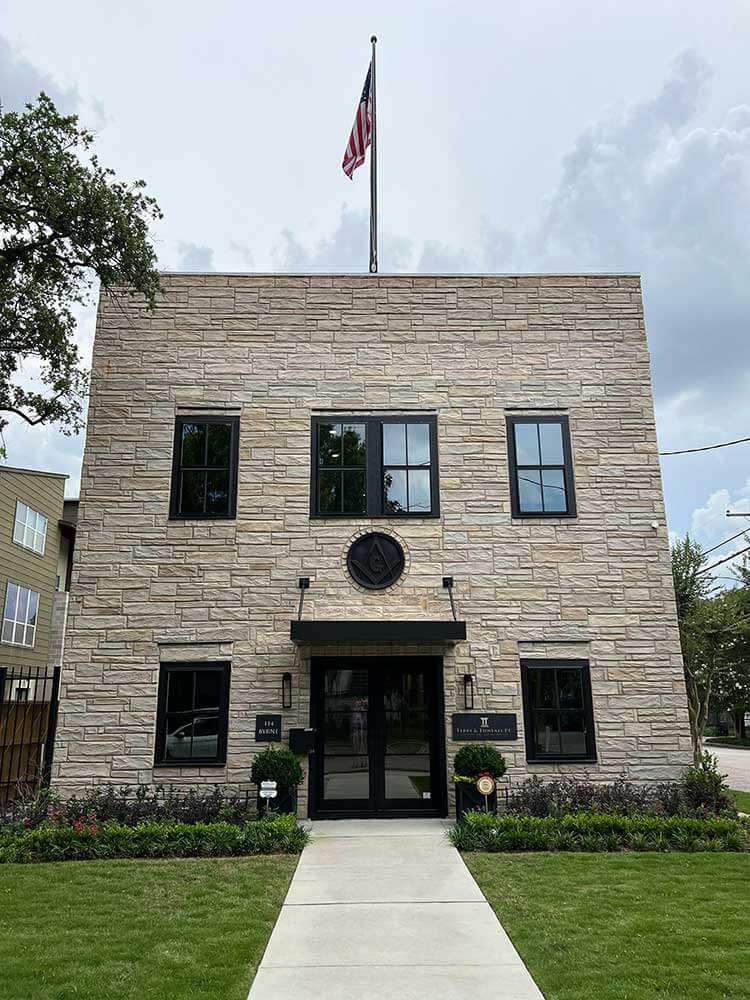 Terry and Thweatt standing in front of their office building